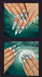 Macro shot of Halloween stiletto press-on nails with eyeball and heart graffiti designs