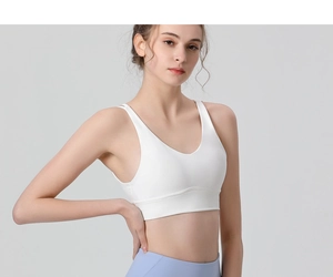 Detail of white high-elastic sports bra with double straps and U-neck for yoga workout
