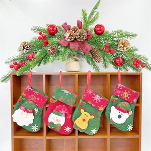 Christmas wreath and felt stockings featuring Santa, snowman and reindeer hanging decor