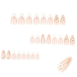 3D floral press-on nails with white French tips and pearl accents on almond shaped tips