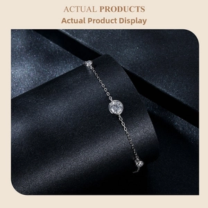 Macro view of sterling silver chain bracelet with three round moissanite stones