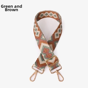 Close-up of green and brown geometric woven bag strap with golden metal buckle