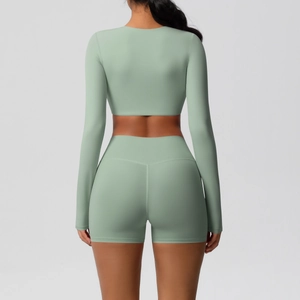 Back view of mint green yoga set with long sleeve crop top and high waist sports shorts