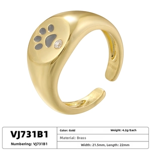 Detail view of gold bear paw ring with gray enamel finish and sparkling rhinestone