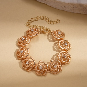 Close-up of gold rose flower chain necklace with sparkling crystals and lobster clasp