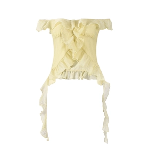 Detail of light yellow strapless top with tiered ruffles and lightweight textured fabric