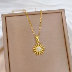 Detail of sunflower pendant with cubic zirconia inlay on elegant gold-plated necklace