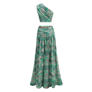 Detail of two-piece tropical leaf print set with off-shoulder top and high waist maxi skirt
