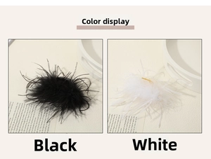Macro detail of fluffy black and white ostrich feather hair claws on elegant tray