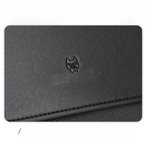 Close-up of black litchi grain leather texture and embossed logo on men's crossbody bag