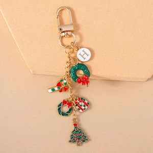 Christmas keychain with golden letter H charm, tree, wreath, and candy cane pendants