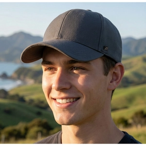 Close-up of a dark grey cotton baseball cap with a subtle metal logo detail on the side