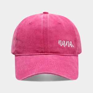 Detailed view of nana embroidery on rose red washed cotton baseball cap with vintage finish