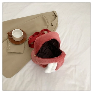 Detailed view of pink faux fur rabbit ears mini backpack with smooth metal zippers