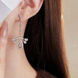 Detailed close-up of zircon teardrop tassel earrings worn for an elegant look
