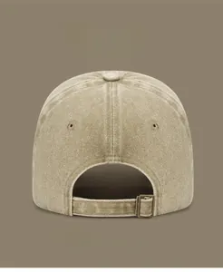 Detail view of washed cotton canvas texture and adjustable metal buckle on baseball cap