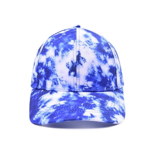 Detailed blue and white tie-dye pattern texture on a classic cotton baseball cap surface