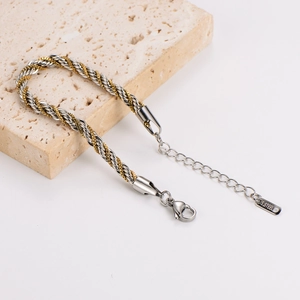 Two-tone hip hop twist rope chain bracelet on stone display with stainless steel tag