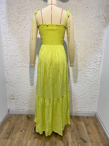Detail of neon green beach maxi dress with elastic smocked back and layered ruffle hem