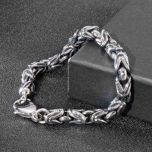 Detailed view of silver 8mm Byzantine chain bracelet heart-shaped on black background