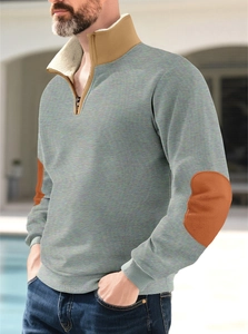 Detail of men's quarter-zip sweatshirt showing khaki collar and brown elbow patch design