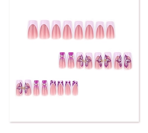 Detail view of pink and purple gradient false nails with 3D floral and pearl accents