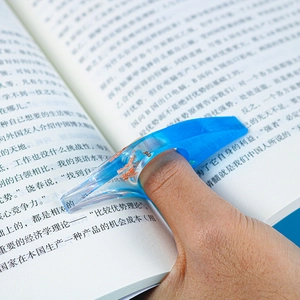 Macro shot of blue resin thumb page holder with gold foil inlay for reading