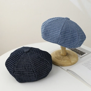 Retro denim newsboy cap in dark and light blue with textured waffle knit pattern
