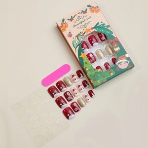 Christmas press-on nail kit featuring 24 red and gold snowflake nails with tools