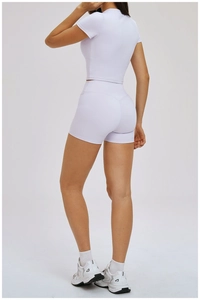 Rear view of slim-fit light purple yoga set featuring high-waist shorts and short-sleeve top
