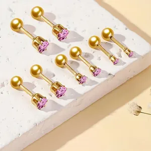 Detail of pink zircon earrings in 18K gold finish with screw-back on stone texture