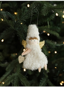 Detail of plush Christmas angel ornament with golden wings on a decorated tree branch