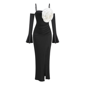 Detail of elegant black off-shoulder gown featuring a large 3D white flower and side slit