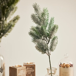 Realistic flocked artificial pine branch with fake snow for festive Christmas decorations