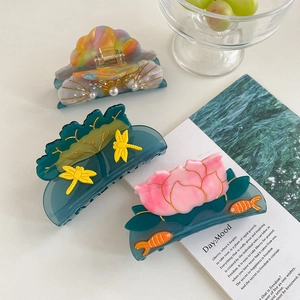 Creative acetate hair claws featuring shell, pearl, and dragonfly designs in a chic layout