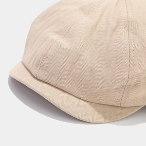 Retro beige herringbone newsboy cap with short brim and classic patchwork texture