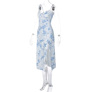 Detail of white midi dress featuring blue floral print and high side slit detail