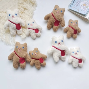 Macro detail of plush teddy bear patches in brown and white grainy fleece fabric