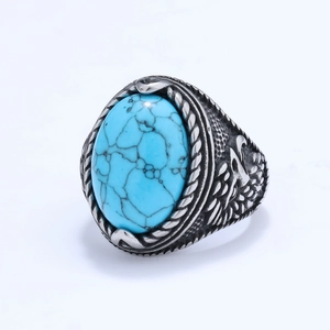 Vintage eagle wing stainless steel ring with turquoise stone shown from a 45-degree angle