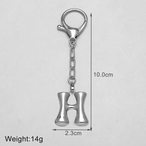 Detail view of silver metal letter H keychain showing dimensions 10cm height and 2.3cm width