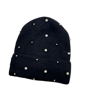 Detail of black knit beanie featuring silver studs and clear rhinestone embellishments