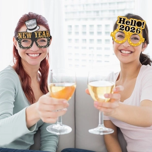 Close-up of 2026 Happy New Year glitter party glasses worn by models at a celebration