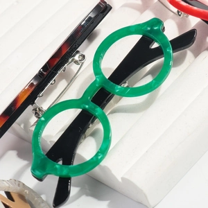 Fashionable green marble round eyeglasses brooch pin on a white display stand