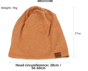 Close-up of orange checkerboard beanie featuring detailed knitting and a leather brand tag