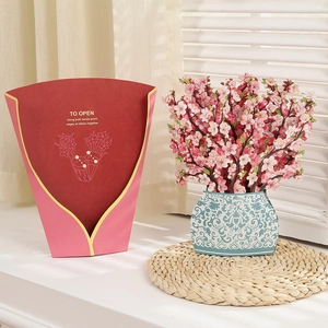 Detail of 3D pop-up greeting card featuring a bouquet of pink paper flowers in a blue vase