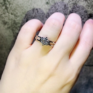 Detailed close-up view of a minimalist 1-carat six-prong solitaire ring on a hand