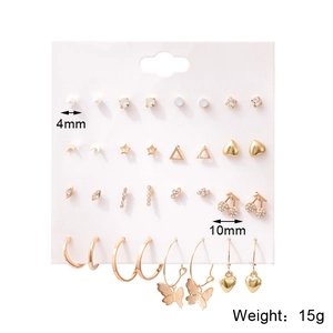 Detail of 16-pair golden alloy earring set showing 4mm studs and 10mm cherry earrings