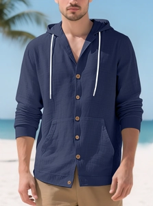Detail of navy cotton linen hooded shirt with wood buttons and drawstring at the beach