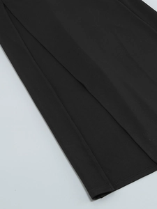 Detailed close-up of high-slit hem and professional stitching on black party dress