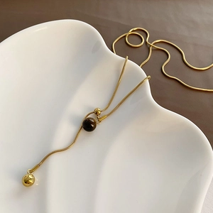 Collier chaîne serpent dorée avec pierre œil de tigre brune et pendentif perle métal